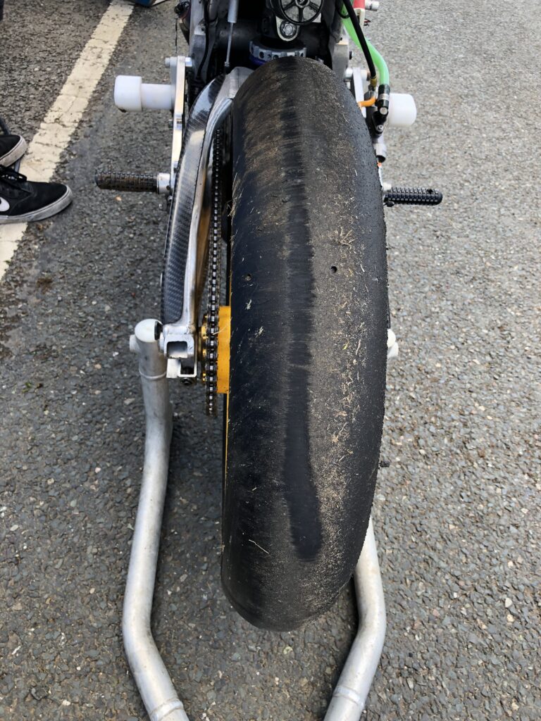 A performance motorcycle with a deep skid mark on the rear tyre.