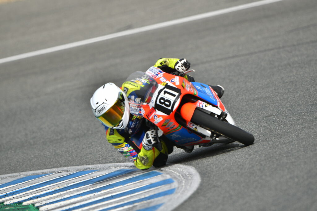 Motorcyclist Harrison Dessoy riding a Honda 250cc NSF through a tight corner.